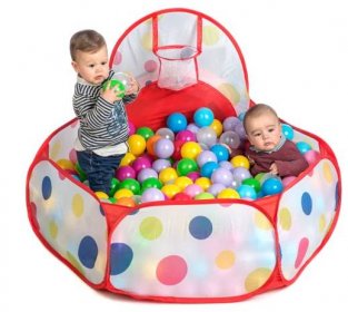 kids playing inside soft play balls pool