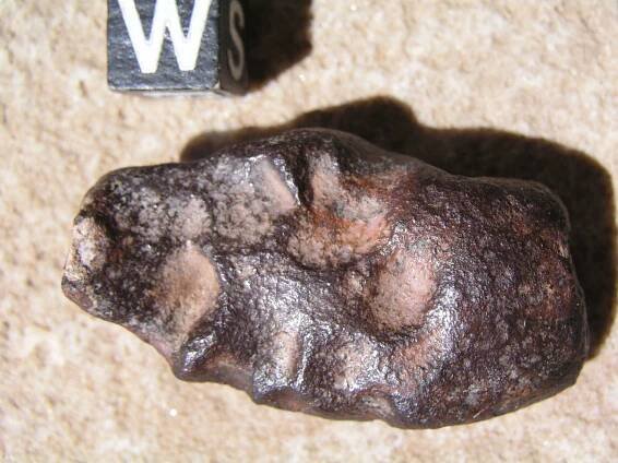 There is a small piece of the chondritic body stuck to it on the left end.