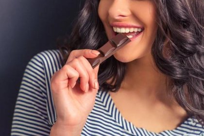 Attractive Girl Eating Chocolate Smiling
