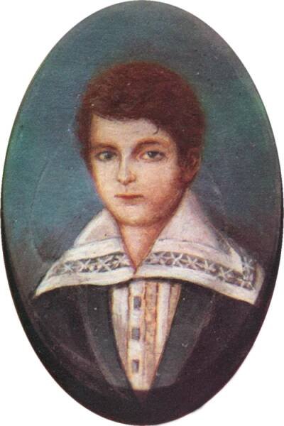 Half-length portrait of a boy with light hair and wearing a jacket over a shirt with an enormous, embroidered collar.