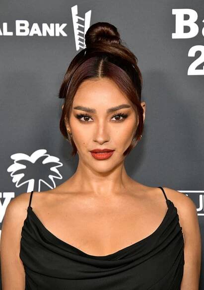 Shay Mitchell wears classic face-framing tendrils and a spaghetti strap black dress
