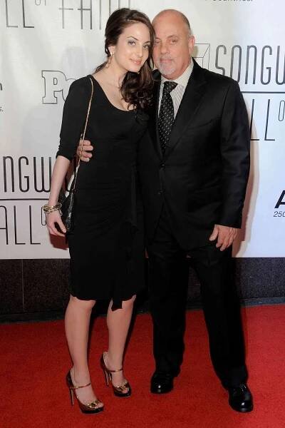Billy Joel with Alexa Ray Joel posing together at an event
