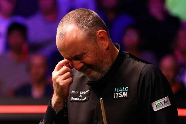 Mark Williams reacts during a snooker match.