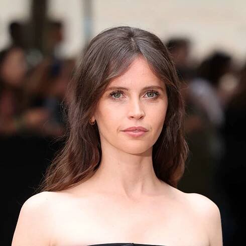 Felicity Jones with curtain bangs and brushed-out waves