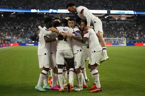 United States players celebrate a goal by Christian Pulisic against Mexico during the second half of a CONCACAF Nations League semifinals soccer match.