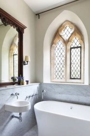 Luxury bathroom in listed building with arched windows