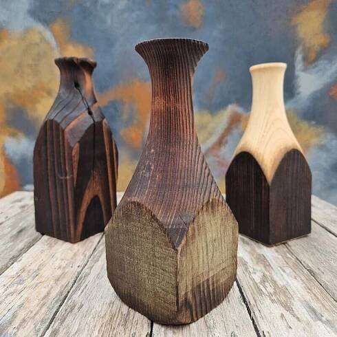 three wooden vases sitting on top of a wooden table
