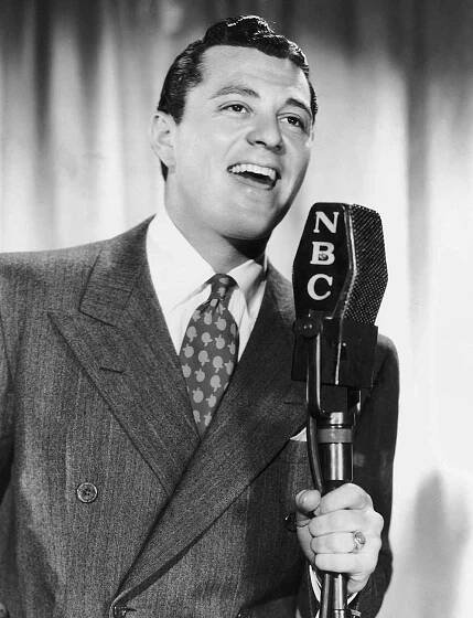 American actor and singer Tony Martin singing on NBC Radio's George Burns and Gracie Allen programme, 7th July 1937