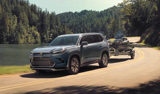 2024 Grand Highlander Hybrid Max towing boat highway