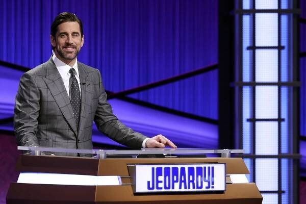 This image released by Jeopardy Productions, Inc. shows Green Bay Packers quarterback Aaron Rodgers as he guest hosts the game show "Jeopardy!"