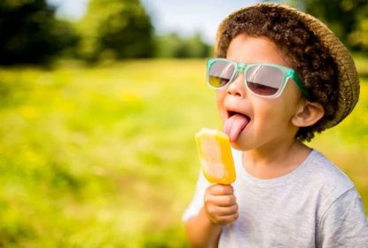 chlapec ve slunečních brýlích a klobouku jíst nanuk venku - zábava entuziasmus - stock snímky, obrázky a fotky