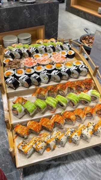 an assortment of sushi on display in a restaurant