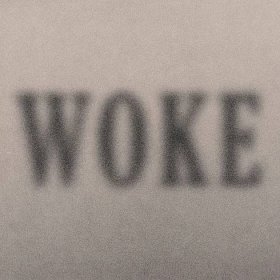 An illustration shows the word “WOKE,” blurred.