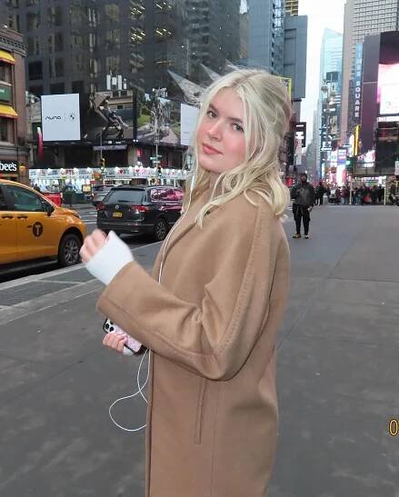 A photo of Lola Sheen standing on a street in New York City in February, from a post dated March 1, 2025 | Source: Instagram/lola_sheen