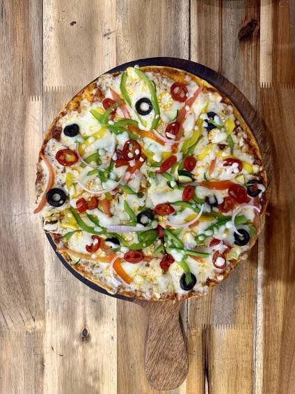  A delicious pizza served on a rustic wooden table.