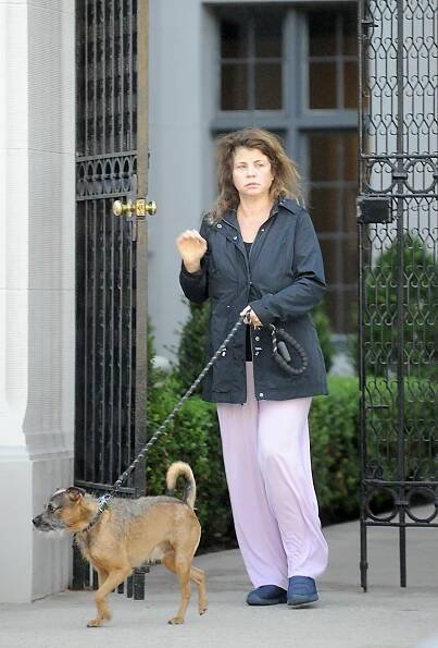 An unrecognizable Yasmine Bleeth, 54, walks her dog