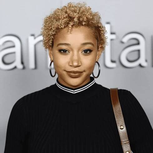 Close up of Amandla Stenberg with a curly pixie cut