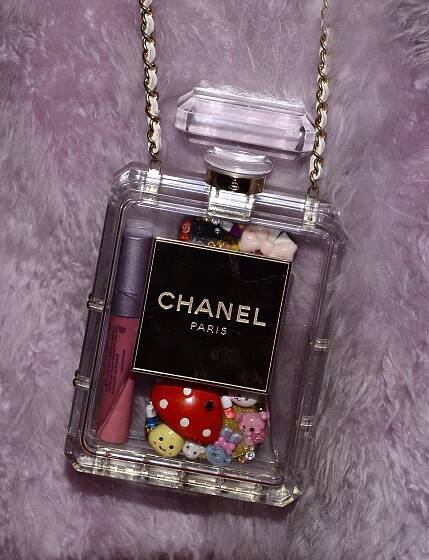A clear Chanel perfume bottle-shaped bag