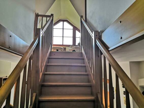 a spiral staircase in a building with a window at Penzion u lázní in Velké Losiny