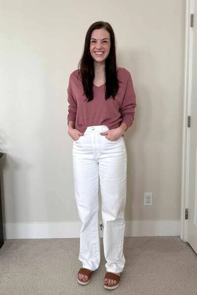 A person stands with their hands in the pockets of the Joe's Jeans The Margot High Rise Straight Jeans