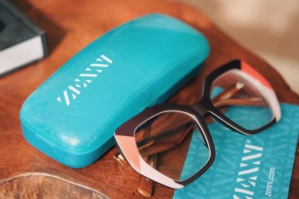 A photo with the Iris Zenni glasses next to its case