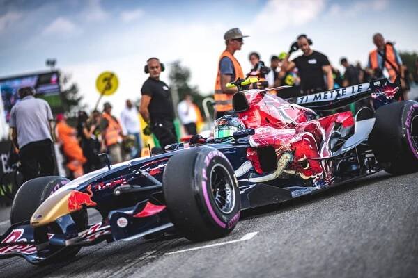 Formula with a standing group of people on the asphalt of the Brno autodrome