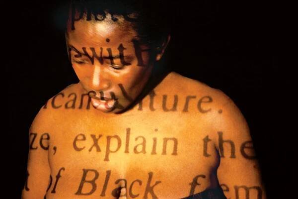 Buseje Bailey,  Explain Black , 1992. Performance with 
slide projects, quilts and audio tape. Photo: Vita Plume.