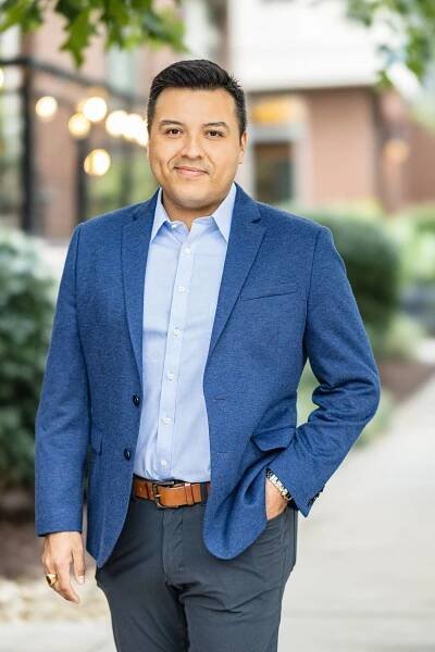 man in blue blazer outside 