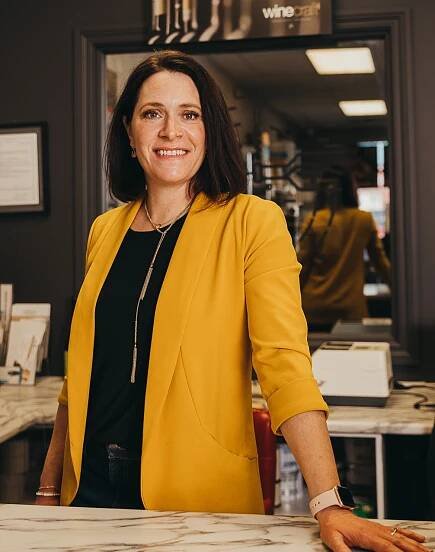Alison Watson, Saskatchewan business owner - Portrait of woman in short bob smiling and wearing a mustard coloured blazer and black blouse