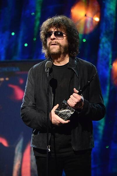 Jeff Lynne of ELO speaks onstage at the Rock & Roll Hall of Fame Induction Ceremony, holding an award.