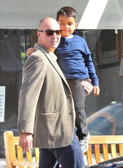 Arnold Vosloo Lovingly Carrying His Child Wallpaper