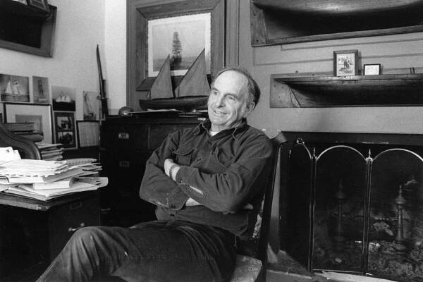 Robert Douglas smiles as he leans back in his chair, sitting in an office in front of a fireplace.
