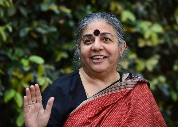 Vandana Shiva with her right hand up