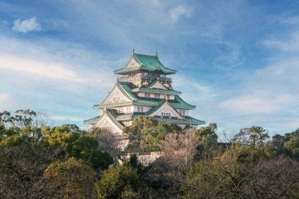 Osaka Castle adorned with accents of gold and turquoise.