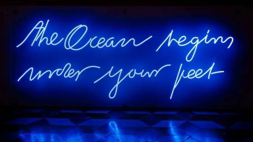 a neon sign that reads the ocean region under your feet