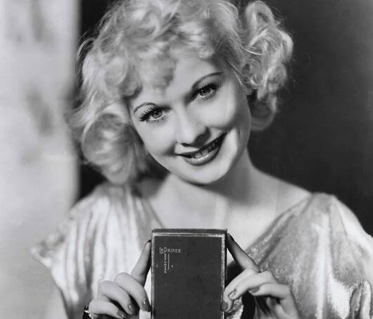 Lucille Ball, at age 22, displaying perfume