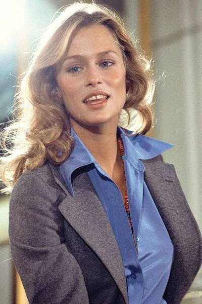 a woman in a blue shirt and grey blazer