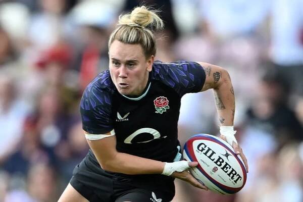 England's Megan Jones running with the rugby ball, being defended by Spain's Gemma Silva.