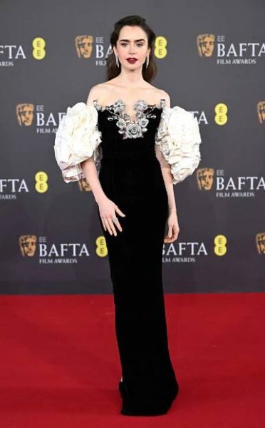Lily Collins wears black and white dress