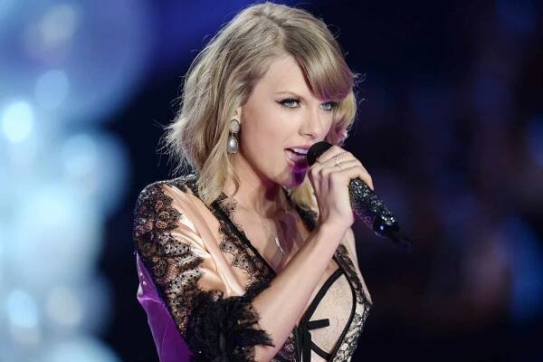 Taylor Swift performs at the Victoria's Secret Fashion Show at Earl's Court. 