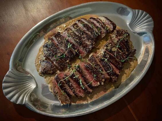 overhead view of sliced steak on a pewter platter 
