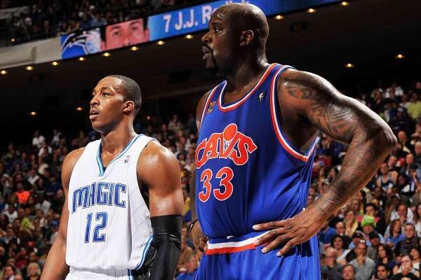 Dwight Howard #12 of the Orlando Magic and Shaquille O'Neal #33 of the Cleveland Cavaliers stand on the court during the game on February 21, 2010 at Amway Arena in Orlando, Florida. The Magic won 101-95.