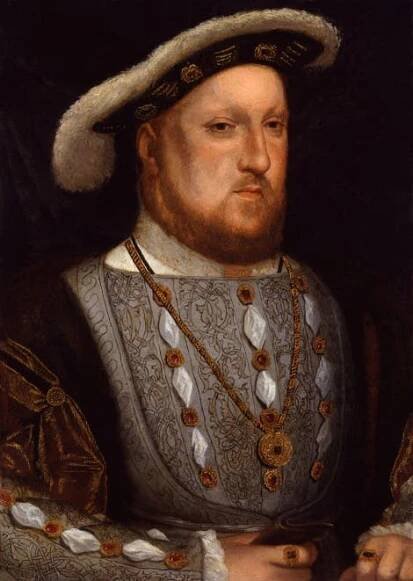 Mid-length portrait of a man with a hat and beard. He looks forward and is wearing a necklace with armour-like clothing.