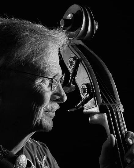 Profile portrait of bluegrass musician and his upright bass.