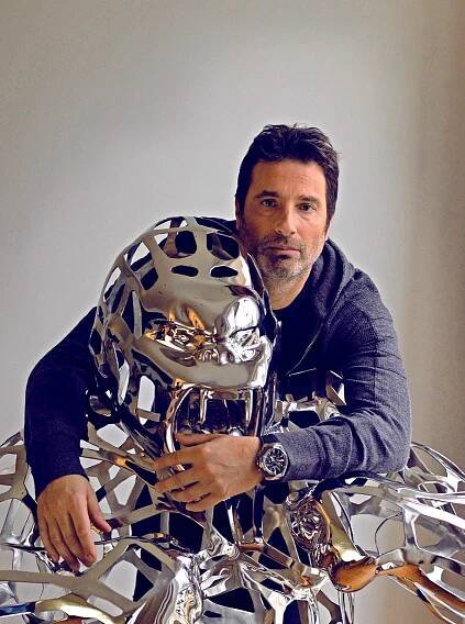 Portrait of artist Richard Orlinski with one of his sculptures 