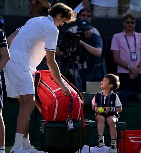 Tennis player Nicolas Jarry with his son after a Wimbledon match.