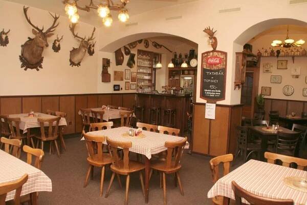 a dining room with tables and chairs in a restaurant at Penzion Aladdin in Teplice