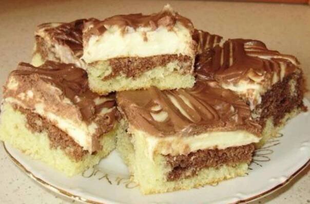 several pieces of cake on a plate with chocolate frosting