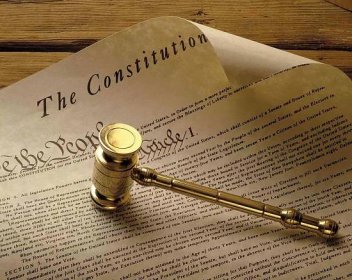 The U.S. Constitution and a brass gavel