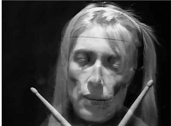 Figure 3. ‘The words come out of yr mouth but yr eyes say other things’. Kim Gordon/skeleton/drummer, 1990, from Sonic Youth ‘Tunic (song for Karen)’ video. 